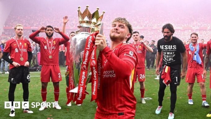 Liverpool midfielder Harvey Elliott lifts the Premier League trophy