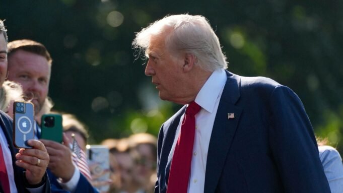 A person shakes hands with US President Donald Trump, on the South Lawn at the White House in Washington, DC, US, July 25, 2025.