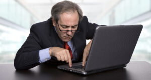 Confused person looking at their laptop