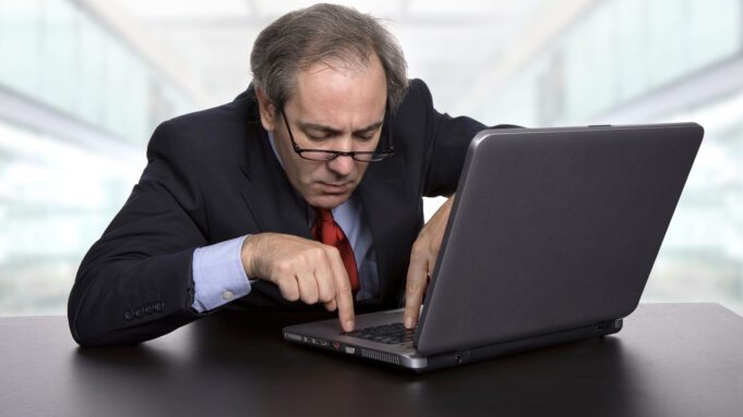 Confused person looking at their laptop
