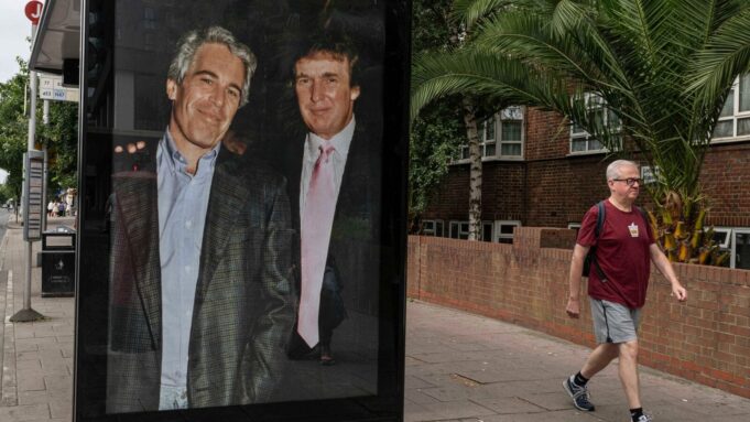 Commuters walk past a bus stop near Nine Elms Station as activists put up a poster showing President Donald Trump and Jeffrey Epstein near the US Embassy in London, Thursday, July 17, 2025.(AP Photo/Thomas Krych)
