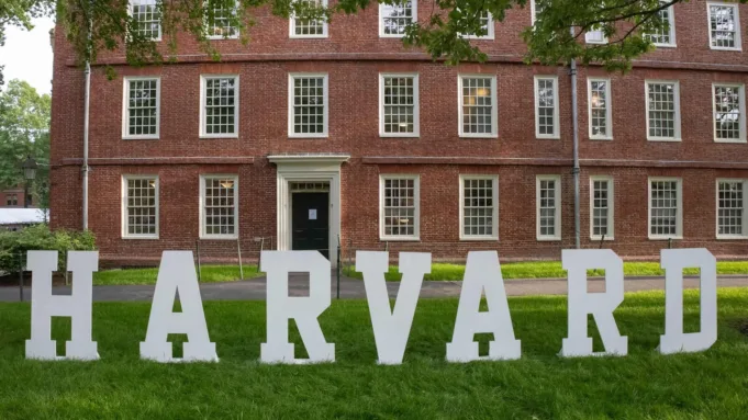 A Harvard sign is seen at the Harvard University campus in Cambridge, Massachusetts, on May 27, 2025. The Harvard university asks a federal judge to restore $2.5B in research grants cut after it rejected ideological demands. (Photo by Rick Friedman / AFP)