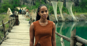 Gaal Dornick standing on a dock and smiling in Foundation season 3 episode 4