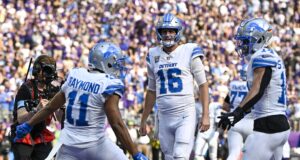 Kalif Raymond #11 of the Detroit Lions celebrates with Jared Goff #16 and Amon-Ra St. Brown #14 after scoring a touchdown in the third quarter of a game against the Minnesota Vikings at U.S. Bank Stadium on October 20, 2024 in Minneapolis, Minnesota.