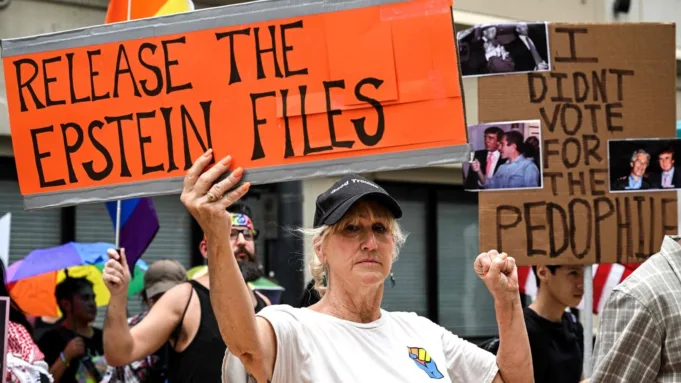 People holds signs calling for the release of files regarding late sex offender Jeffrey Epstein participate in a protest as part of the 'Good Trouble Lives On' national day of action against the administration of US President Donald Trump in Houston, Texas, on July 17, 2025.