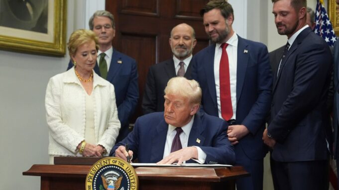 President Donald Trump signs an executive order on Thursday, July 31, 2025, in the Roosevelt Room of the White House in Washington.