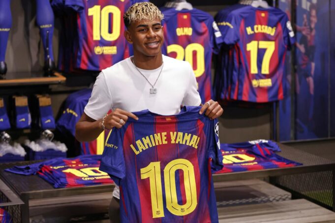 Lamine Yamal poses with the decorated number 10 shirt.