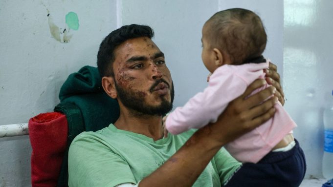 Gopal, an army member who was rescued from Dharali village after it was hit by landslides, plays with his child as he recovers at a district hospital in Uttarkashi, Uttarakhand, India, August 7, 2025. REUTERS/Francis Mascarenhas