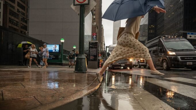 Pedestrians during a rainstorm in New York, US, on Thursday, July 31, 2025. New York City commuters are bracing for potential flooding from heavy rain Thursday, just hours after an unrelated power outage that continued to snarl subways late into the afternoon. Photographer: Victor J. Blue/Bloomberg