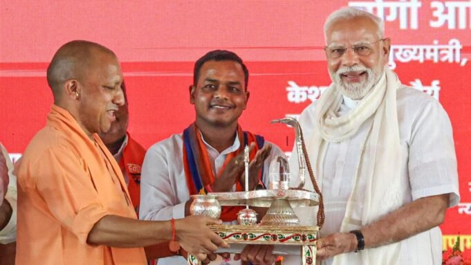 Prime Minister Narendra Modi at a public meeting, in Varanasi on August 2, being felicitated by Uttar Pradesh Chief Minister Yogi Adityanath.